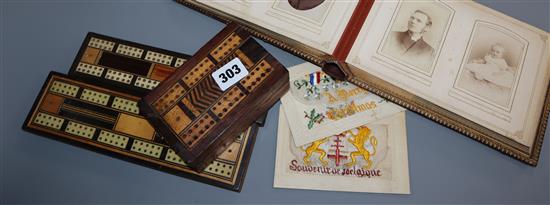 A Victorian photo album, two cribbage boards, a cribbage box and two silk cards